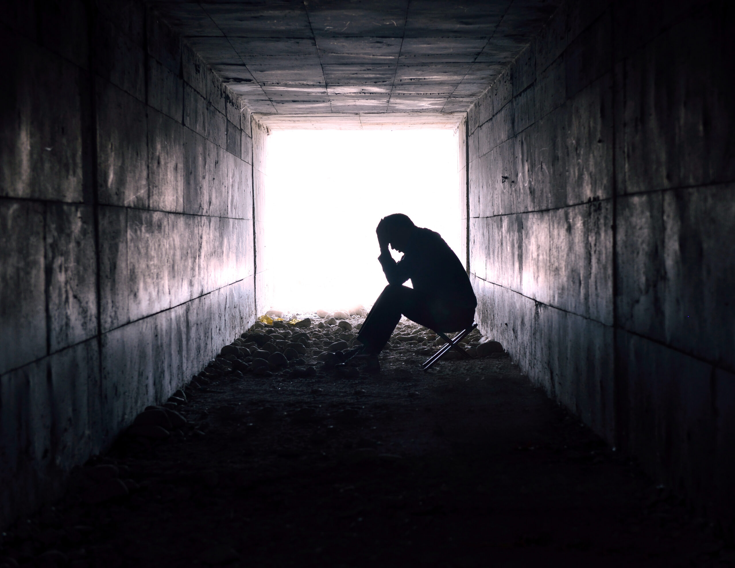 Depressed,Man,Sitting,In,The,Tunnel